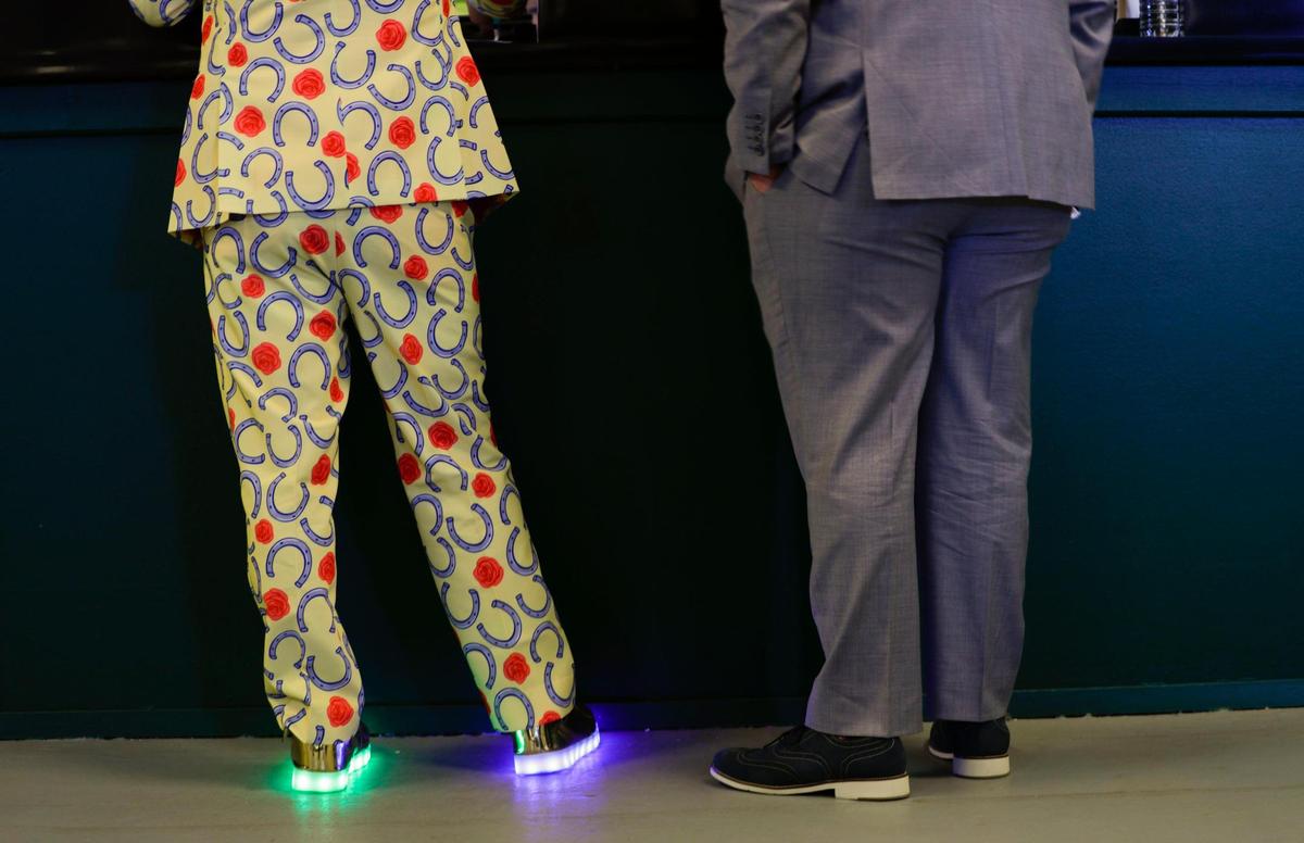 Dustin Neel shows off his neon shows that he ordered from Amazon at Churchill Downs in Louisville, Ky., Saturday, May 1, 2021.