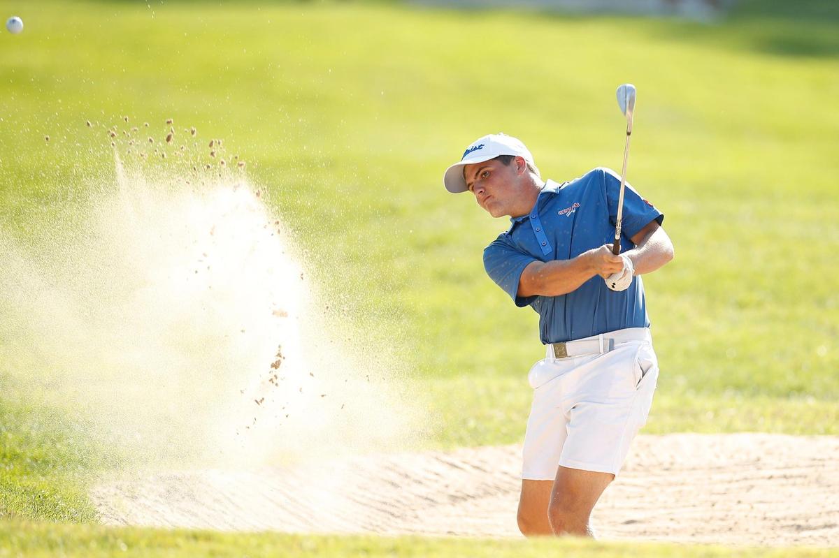 Madison Central’s Hayden Wasch hits from the bunker on No. 18 during the Region 9 boys’ golf championship at Gibson Bay Golf Course in Richmond on Tuesday.