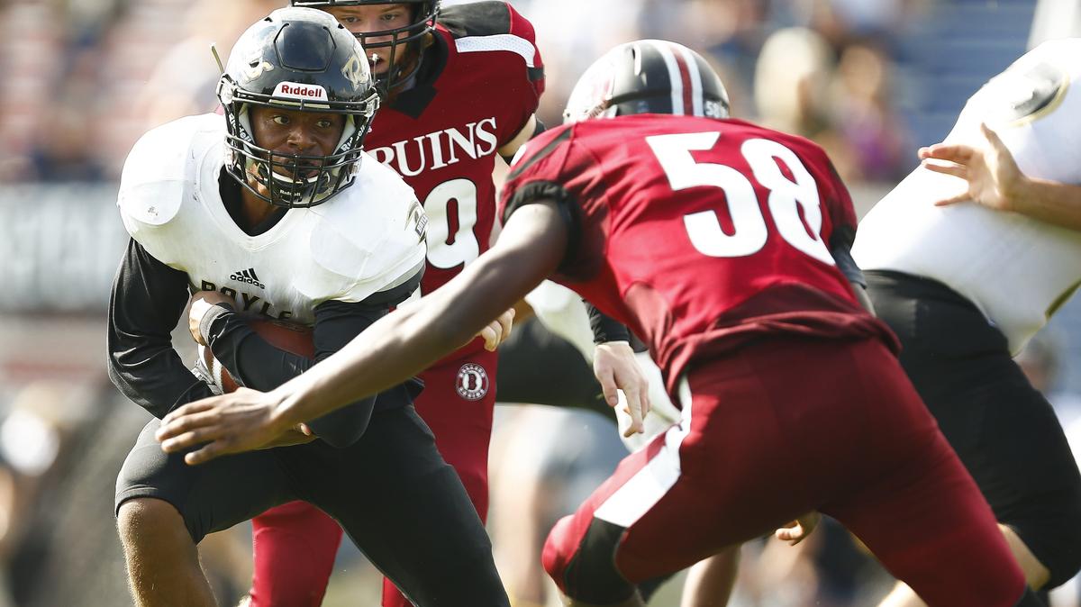 Boyle County’s Landen Bartleson (24) carried the ball past Ballard’s Terran Hearn (58) during the Little Caesars Fort Harrod Bowl last Saturday at Alvis Johnson Field in Harrodsburg. Boyle County beat Ballard 35-21.