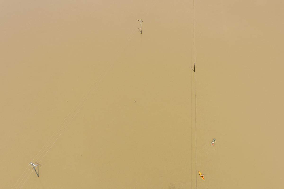 People kayak along flooded Kentucky Route 39 near Crab Orchard in Lincoln County on Friday, April 4, 2025.  