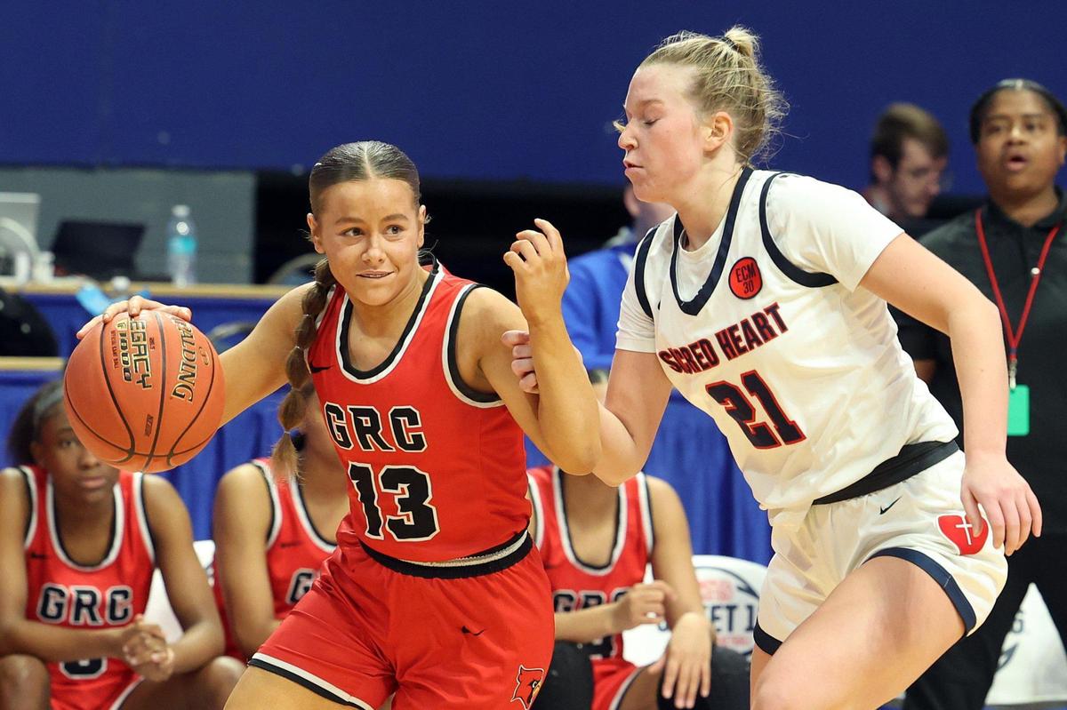 George Rogers Clark’s Jaylynn Goodwin (13) is guarded by Sacred Heart’s Reagan Bender (21) during thei Sweet 16 semifinals.