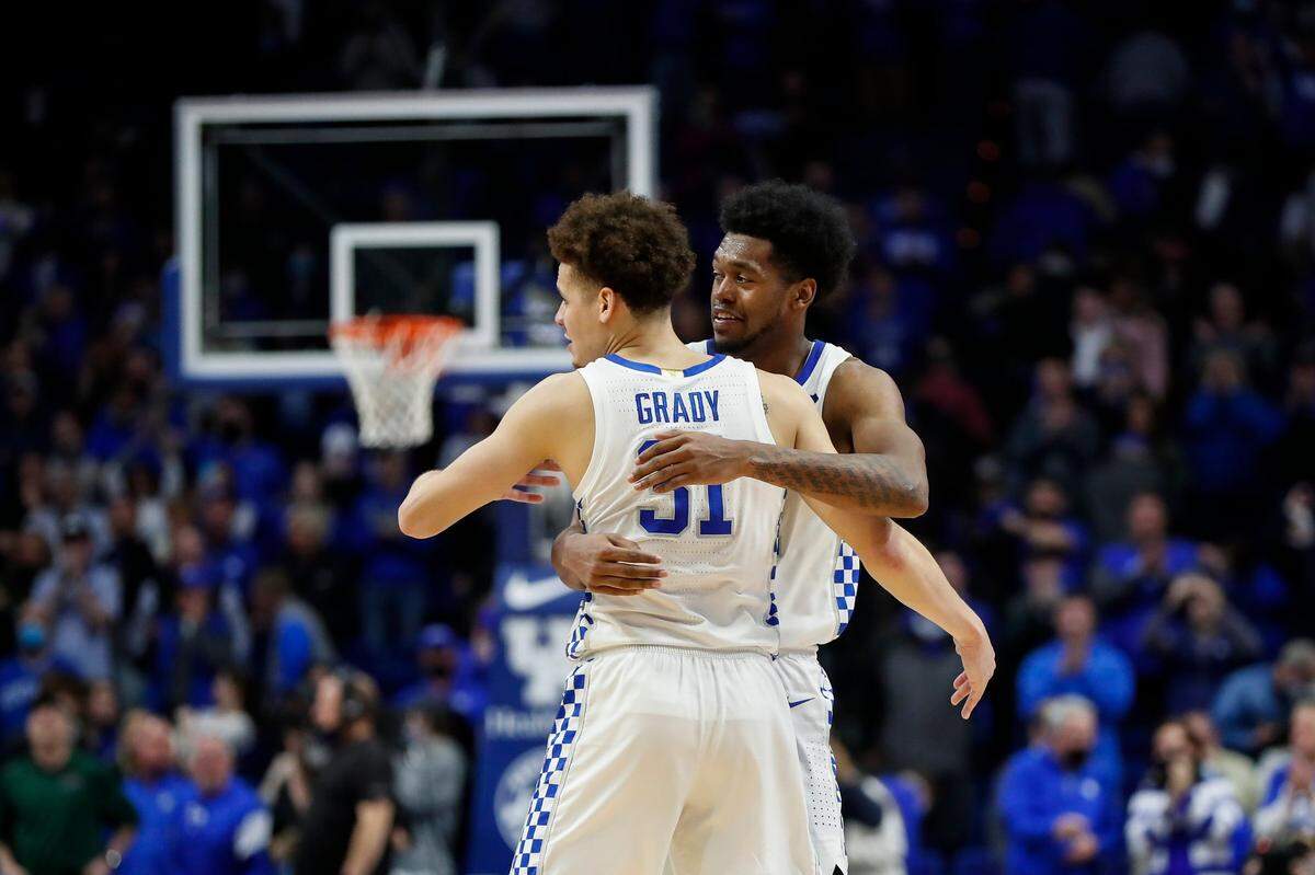 Kentucky Wildcats guard Kellan Grady (31) and Kentucky Wildcats forward Keion Brooks Jr. (12) hug after defeating the Mississippi State Bulldogs in over time during the game at Rupp Arena in Lexington, Ky., Tuesday, January 25, 2022.