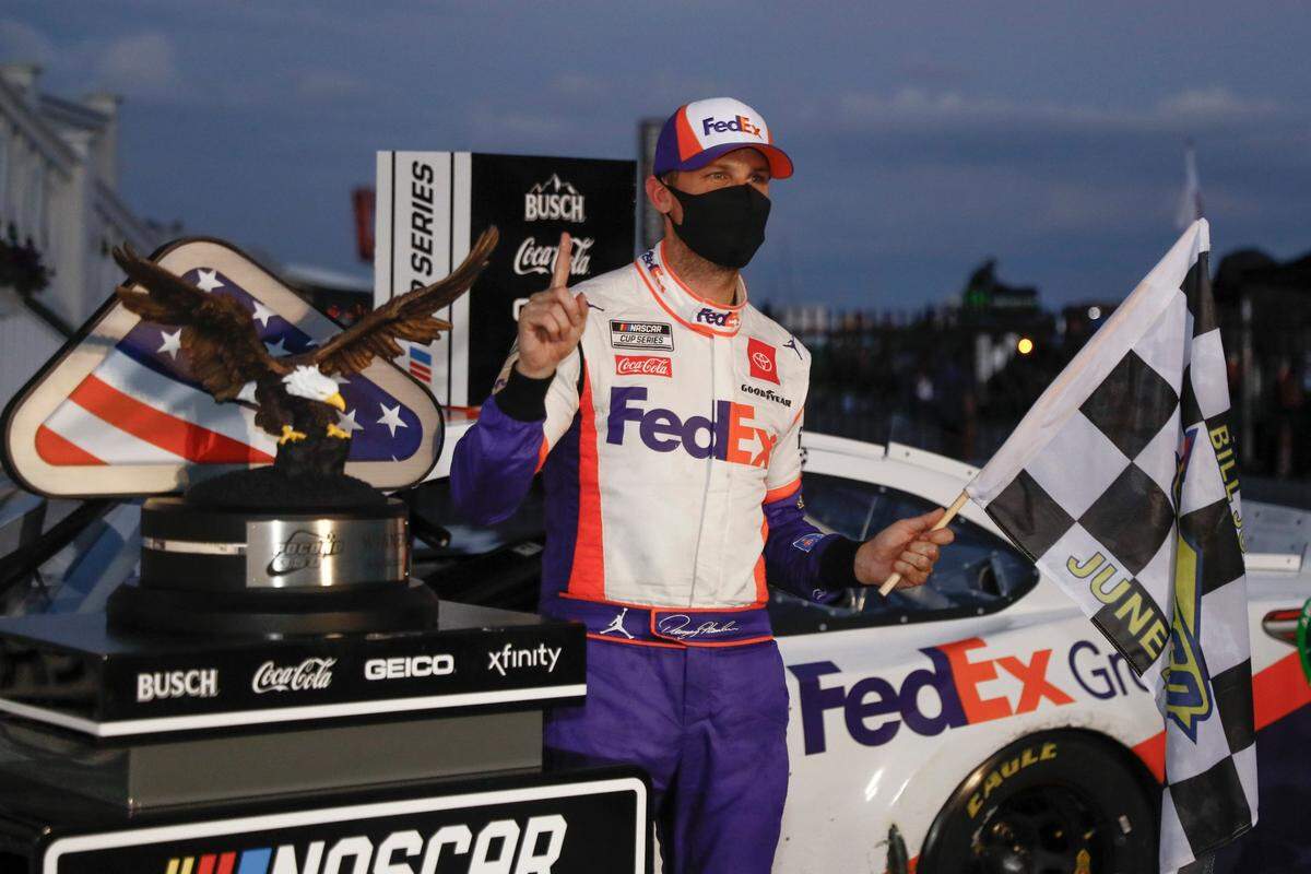 Denny Hamlin, with his NASCAR-mandated face mask in place, celebrated after winning the Pocono 350 at Pocono Raceway last Sunday.