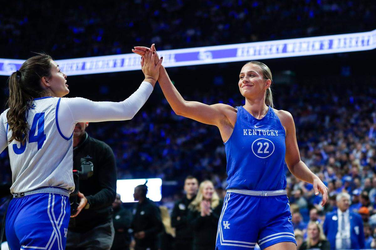 Kentucky guard Maddie Scherr (22) shares a high-five with teammate Emma King after winning the women’s 3-point shooting contest during Big Blue Madness.