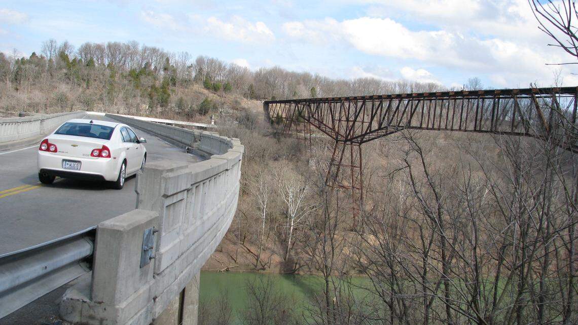 A car rounded a curve on the U.S. 62 bridge next to Young's High Bridge over the Kentucky River between Anderson and Woodford counties. Young's High Bridge, an old railroad trestle, soon will become a platform for bungee jumping, according to the company Vertigo Bungee.     