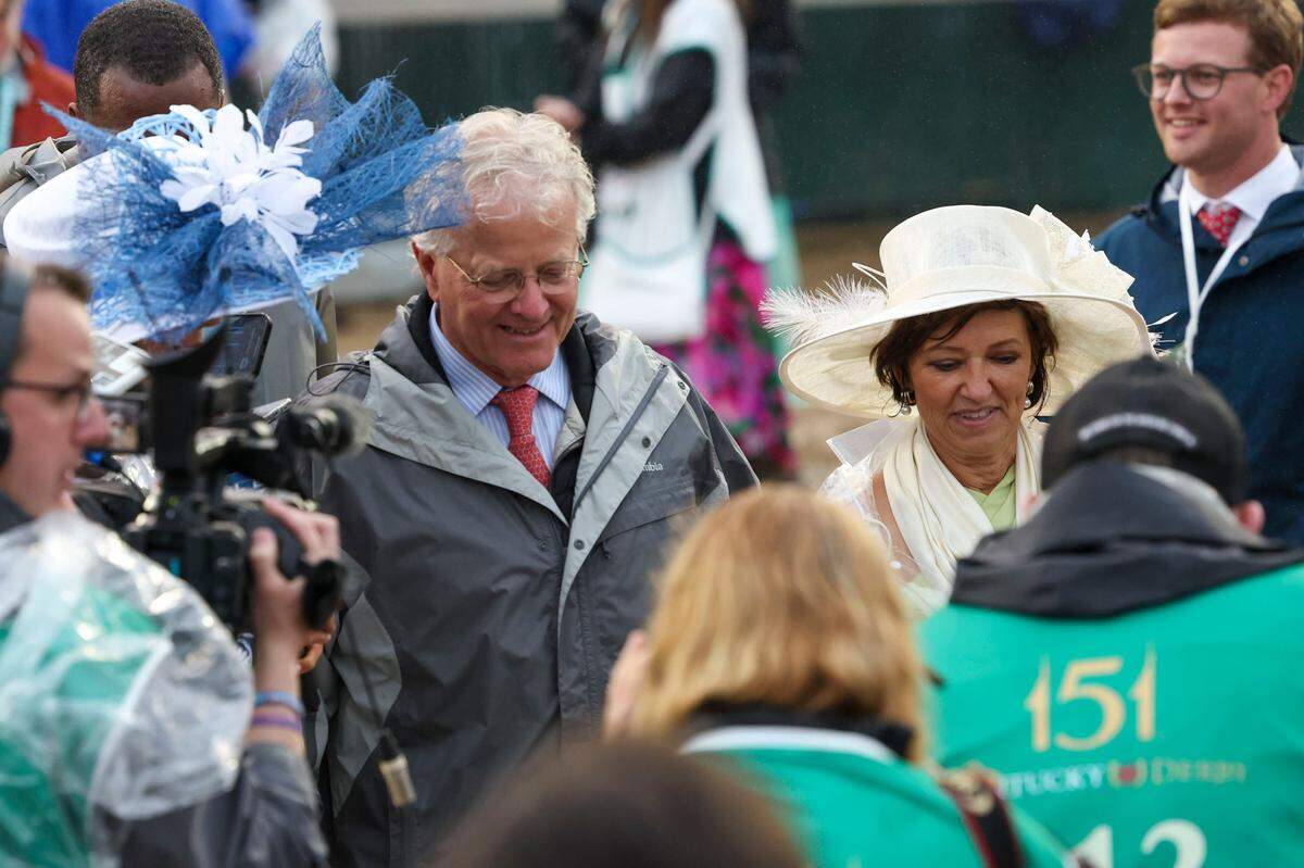 Trainer Bill Mott and his wife, Tina, make their way to the winner’s circle after Sovereignty won the 151st Kentucky Derby.