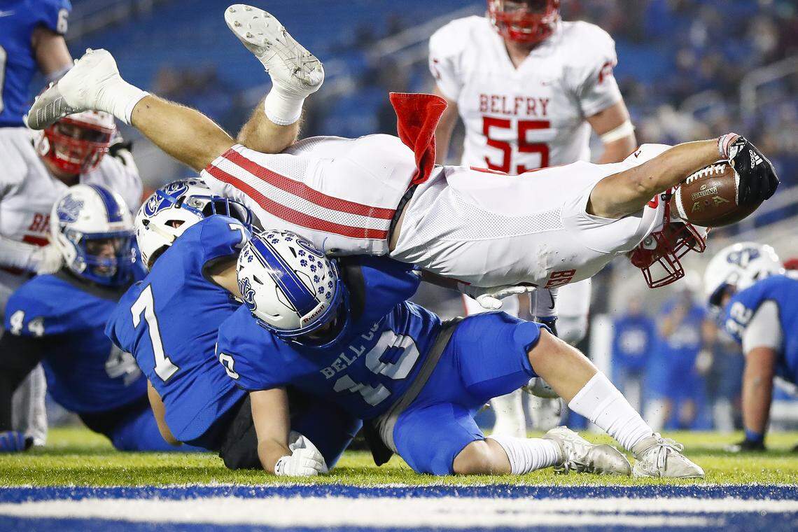 Belfry’s Isaac Dixon (3) leaps for extra yards over Bell County’s Brant Hoskins during the Class 3A 2019 UK Orthopaedics/KHSAA Commonwealth Gridiron Bowl state championship game at Kroger Field in Lexington, Ky., Friday, Dec. 6, 2019. Belfry defeated Bell County 30-20.