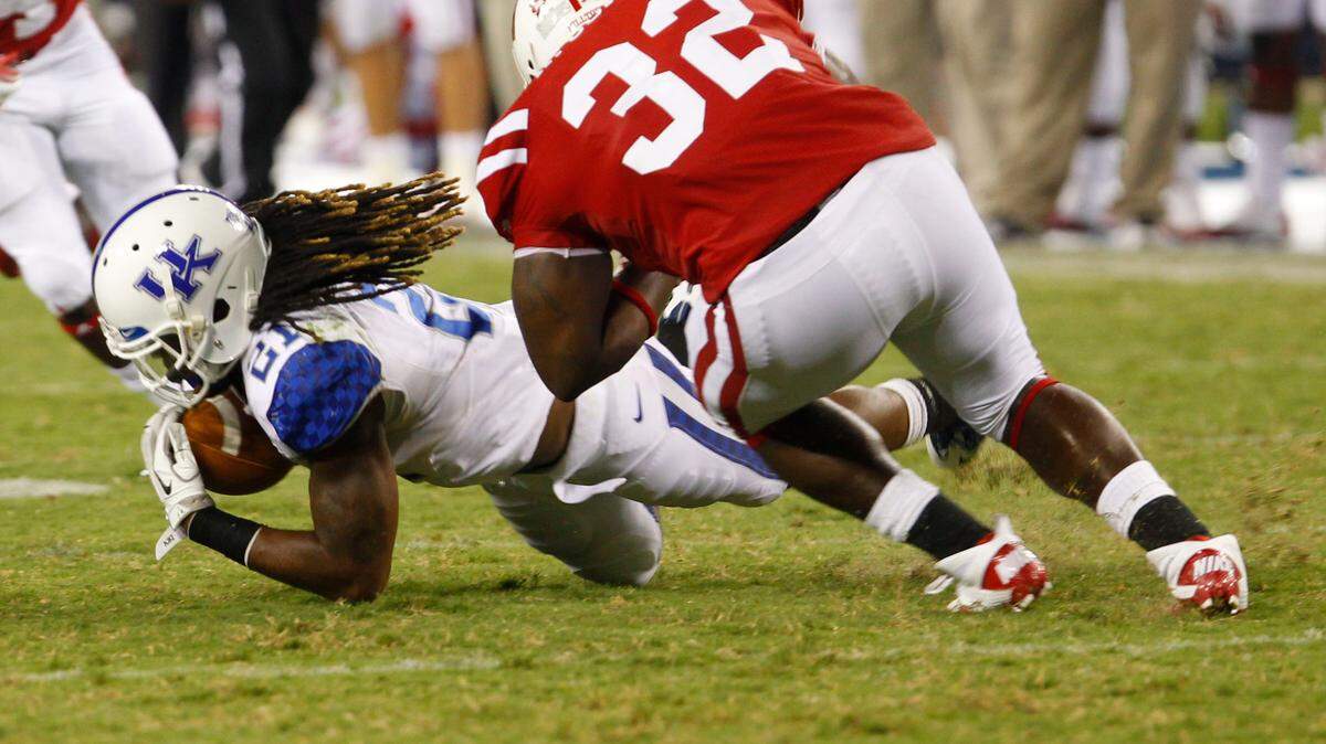 Kentucky's Winston Guy picked off a pass by Hilltoppers quarterback Kawaun Jakes  during the Cats' season opener against Western Kentucky.    