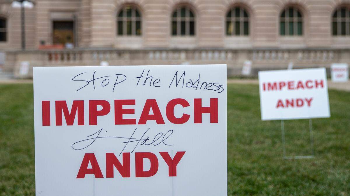 Signs calling for the impeachment of Kentucky Gov. Andy Beshear were placed on the lawn of the state Capitol in Frankfort, Ky., on Tuesday, Jan. 5, 2021.