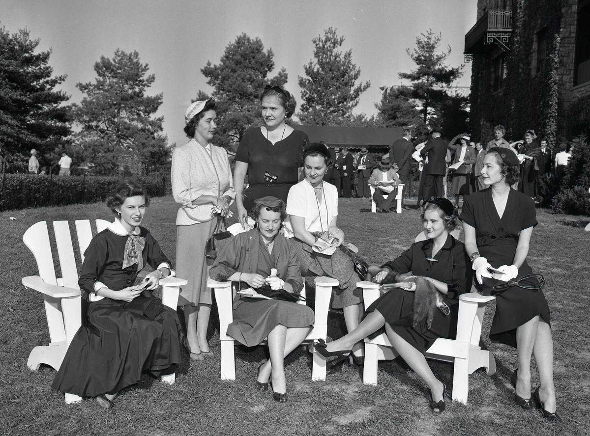Patrons enjoying the clubhouse lawn at Keeneland Race Course in October 1954 included, seated from left to right, Mrs. William Carl, Mrs. W.T. Bishop, Mrs. Charles Rhodes, Mrs. Harry Scott Jr. and Mrs. Richard Arnspiger. Behind them were Mrs. Warren Wright Jr. and Mrs. Jack Wilkinson.
