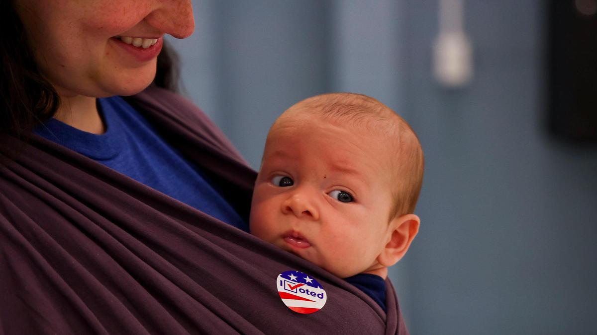 A baby boy checks out voters as they cast their ballots in the 2024 general election at Lansdowne Elementary School, Tuesday, November 5, 2024 in Lexington, Ky.