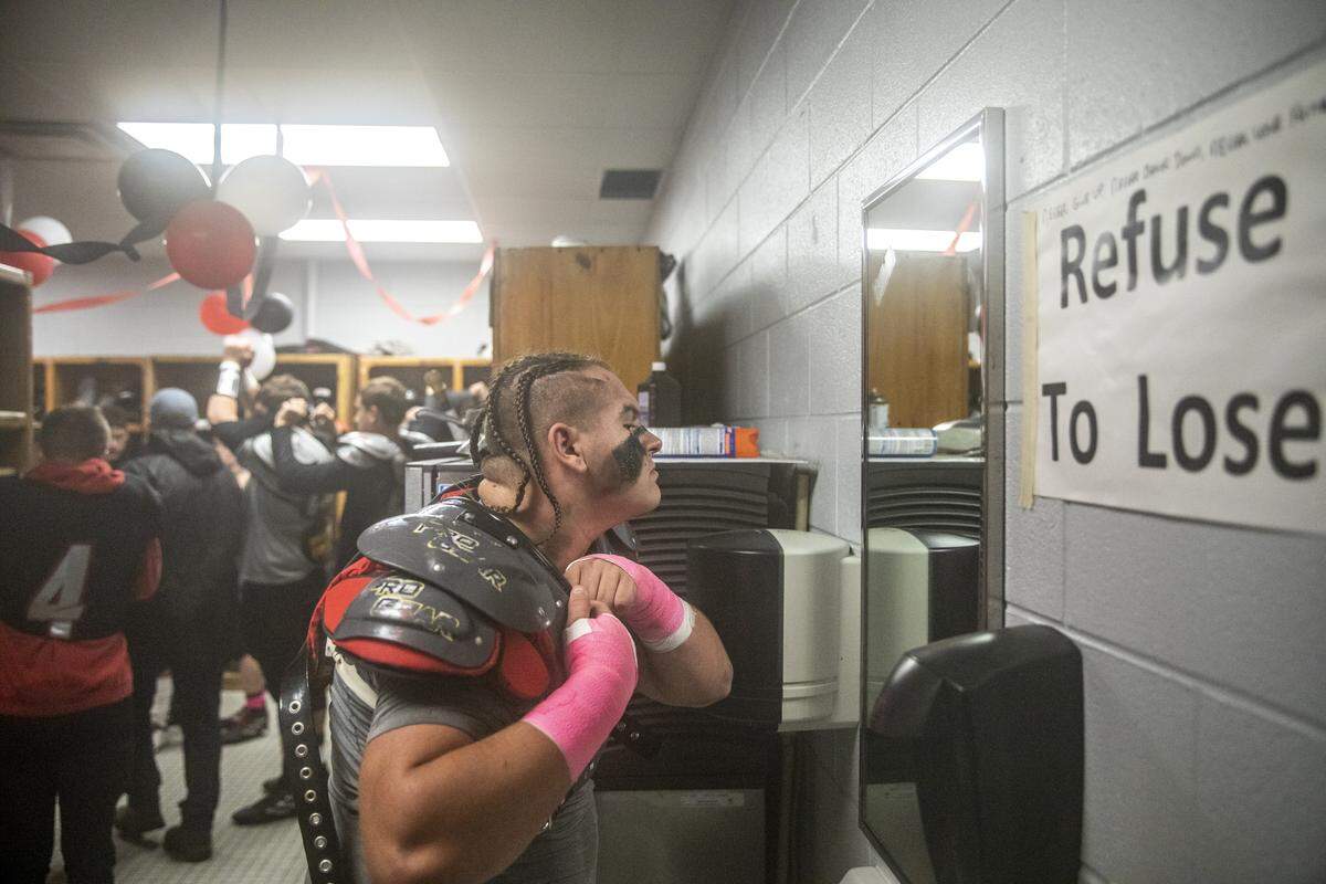 Harlan County’s Hunter Blevins gets ready in the locker room.