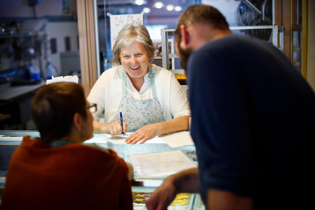 Le Matin Bakery co-owner Debbie Larian laughs with customers while taking a lunch order at Le Matin on Tuesday. Le Matin will close after 37 years of operation on Aug. 31.