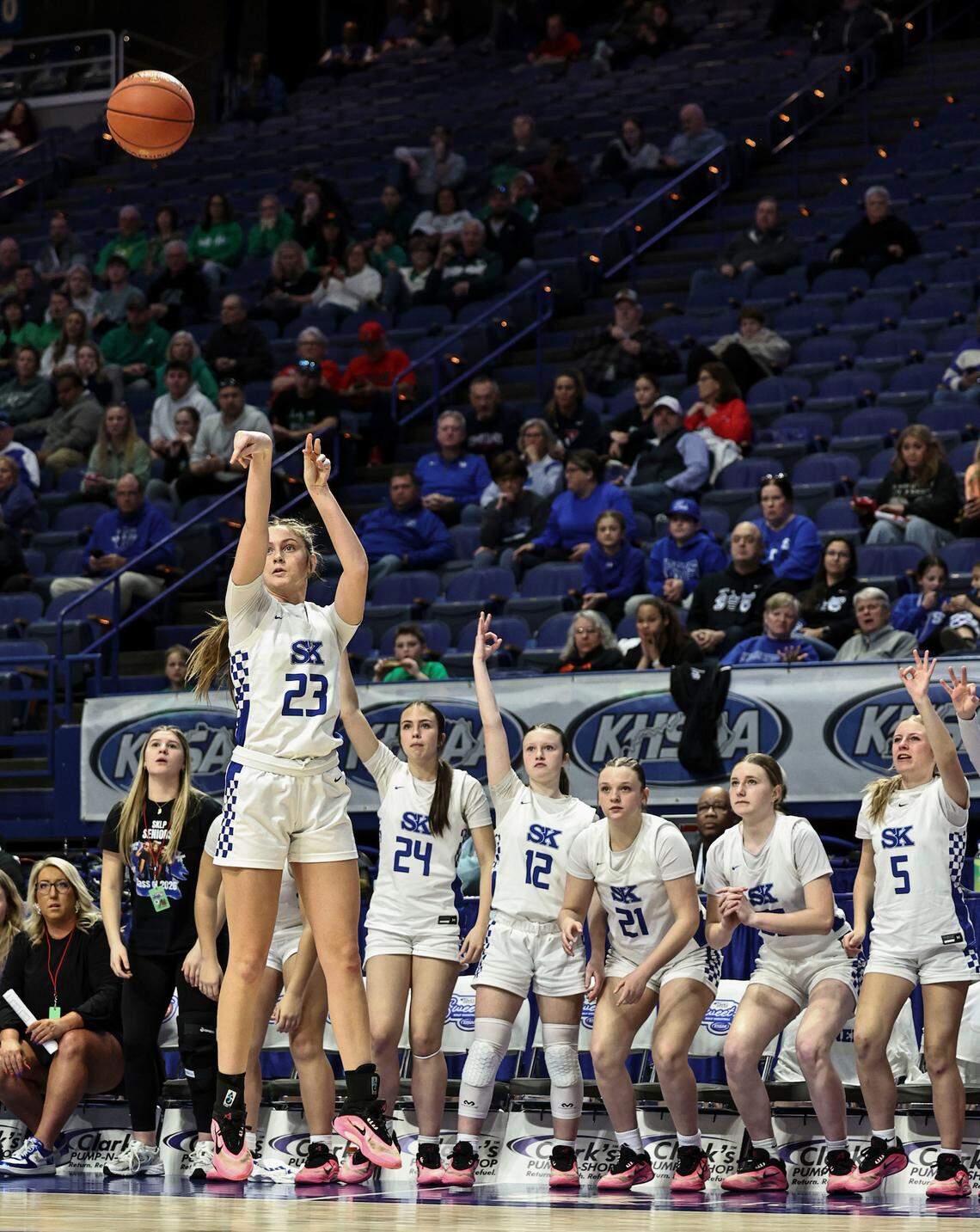 Simon Kenton’s Anna Kelch shoots a 3-pointer at the close of the third quarter against Owensboro Catholic as the Pioneers’ bench anticipates it going in during the Clark’s Pump-N-Shop Girls’ Basketball Sweet 16 quarterfinals at Rupp Arena on Friday.