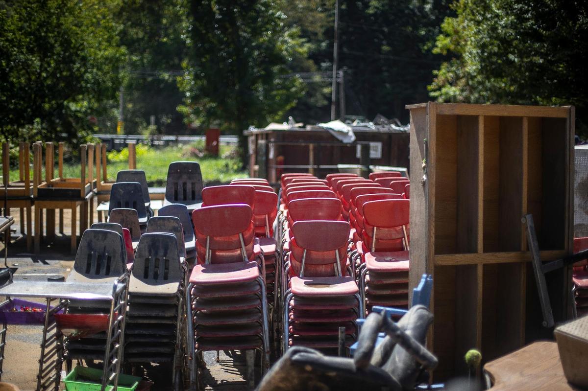 Chairs, desks and other school furniture sit outside Martha Jane Potter Elementary School in Kona, Ky., on Wednesday, Aug. 31, 2022. The school was damaged by flooding in late July.