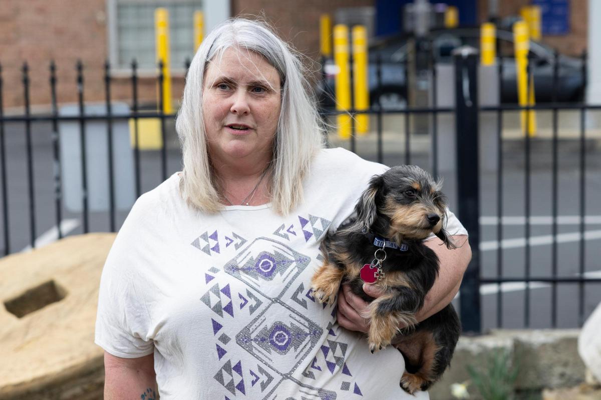 Members of SPARK Ministries take foster dogs for a walk at Millstone Park in Richmond, Kentucky, on Thursday, March 14, 2024. SPARK Ministries works to remove barriers for people who are recovering from addiction.