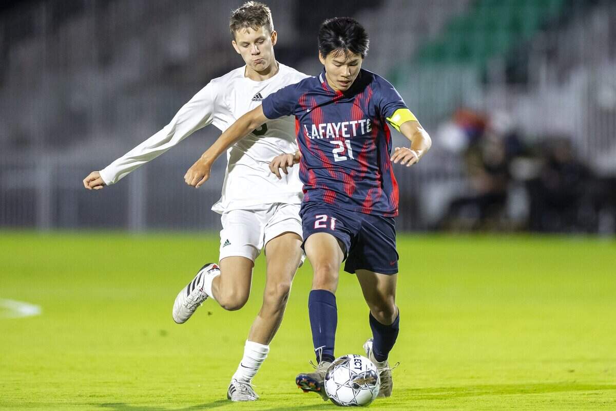 Lafayette's Rylan Chau (21) dribbles the ball as Frederick Douglass's Clayton Wallace (5) follows during a game at Lexington Sporting Club stadium in Lexington, Ky., on Thursday, Sept. 25, 2025.