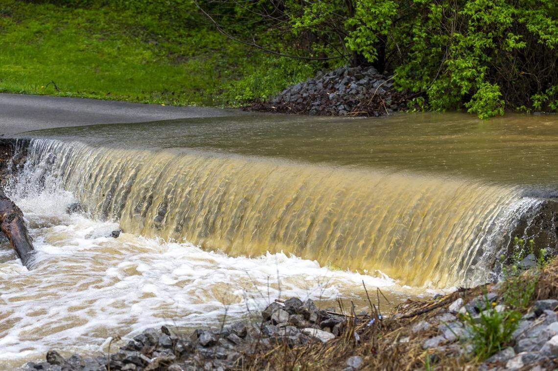 Water rushes over a driveway in Lincoln County, Ky., on Friday, April 4, 2025.