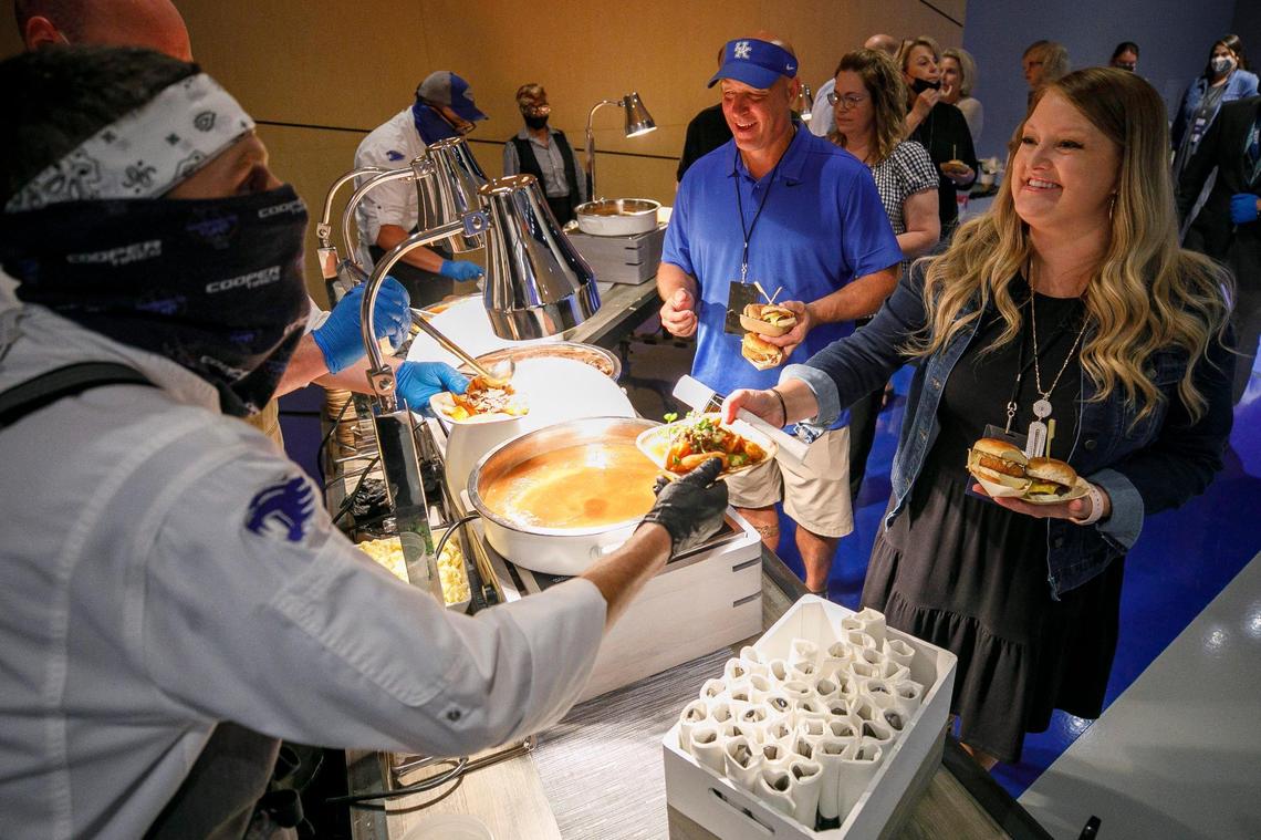 Michael Creech, center, and Andrea Creech, both of Lexington, make their way through the hors d’oeuvres In the new VIP Club before comedian Jim Gaffigan takes the stage at Rupp Arena Aug. 18, 2021. The new club offers an exclusive experience including VIP parking, a private entrance, premium club seating, and complimentary food and soft drinks.