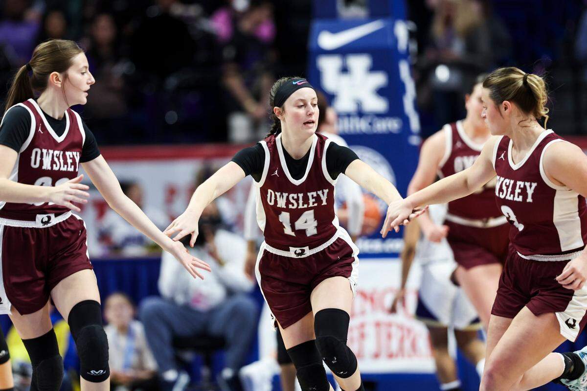 Owsley County’s Carly Smith (14) celebrates a bucket with teammates on her way to scoring 14 points Wednesday. The Owls were making the school’s first Sweet 16 appearance for boys or girls.