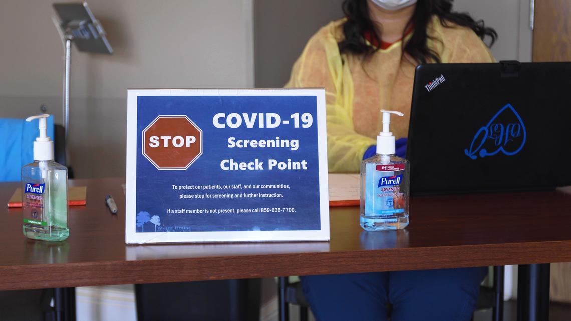 All building occupants entering the White House Clinic in Richmond is screened by staff at a desk in the entrance to see if they show symptoms of COVID-19 coronavirus, March 27, 2020. Patients showing any possible symptoms are asked to return to their car where they will be further treated.