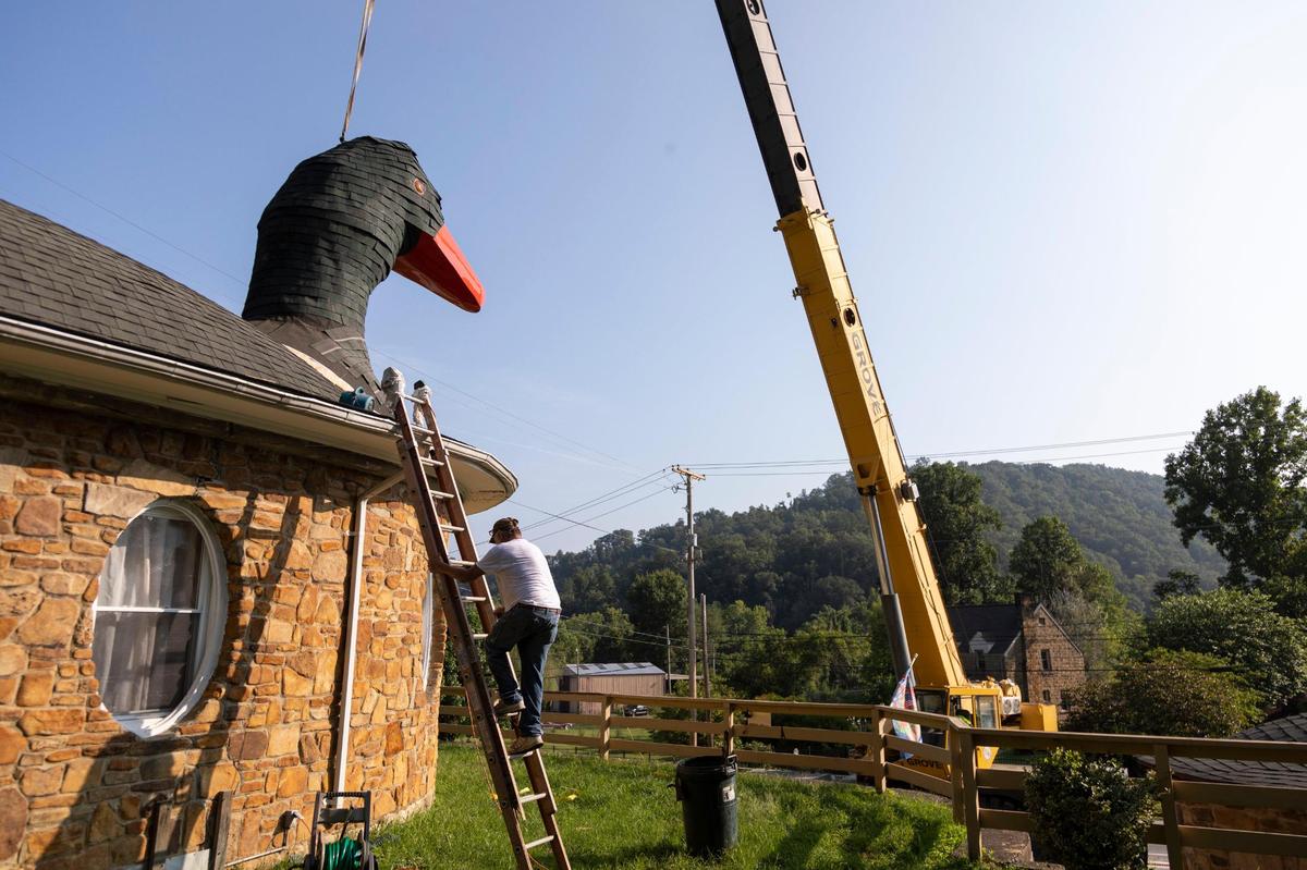 The head of the Mother Goose Inn in is replaced after collapsing from winter storms in Hazard, Ky., on Friday, August 27, 2021. The over 17-foot-tall gooses head fell after remaining in place over eighty years. Keith Miller worked on repairing and installing the structure.