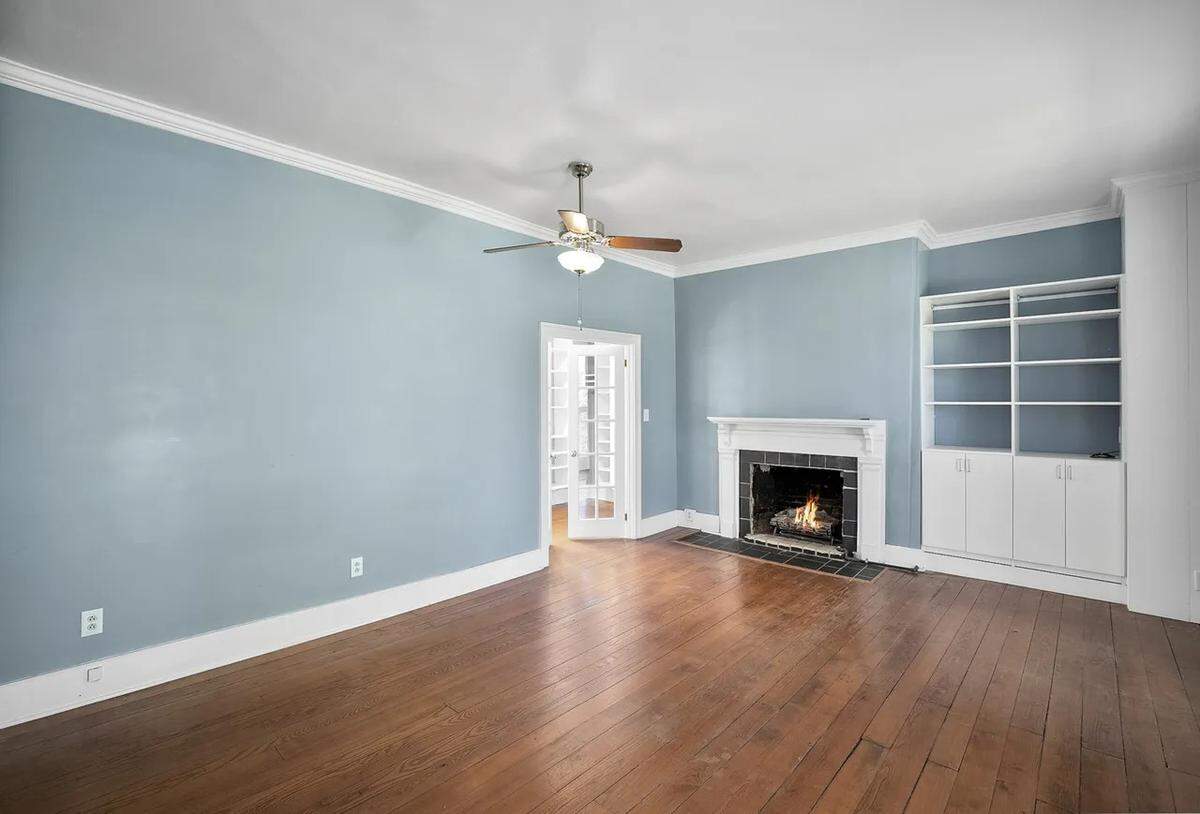 A view of an upstairs bedroom with an adjoining walk-in closet.