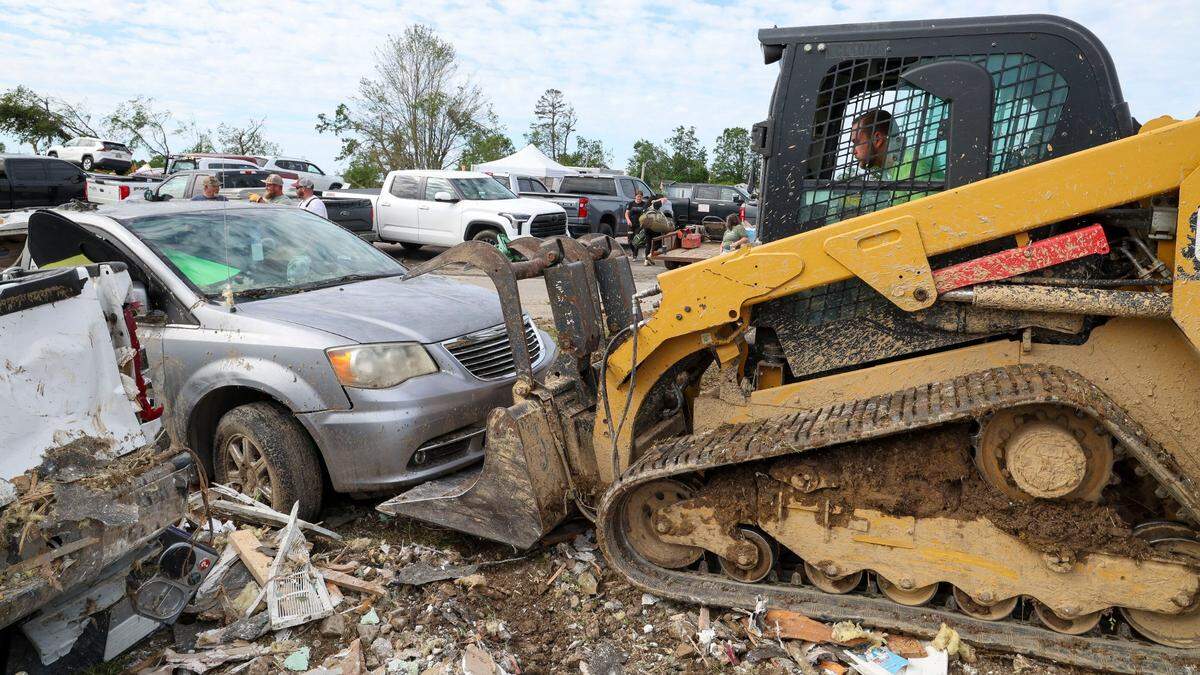 Melvin Brock removes a car from the Sunshine Hills neighborhood, Sunday, May 18, 2025 in London, Ky. Two days earlier, a deadly tornado ripped through the neighborhood destroying homes.