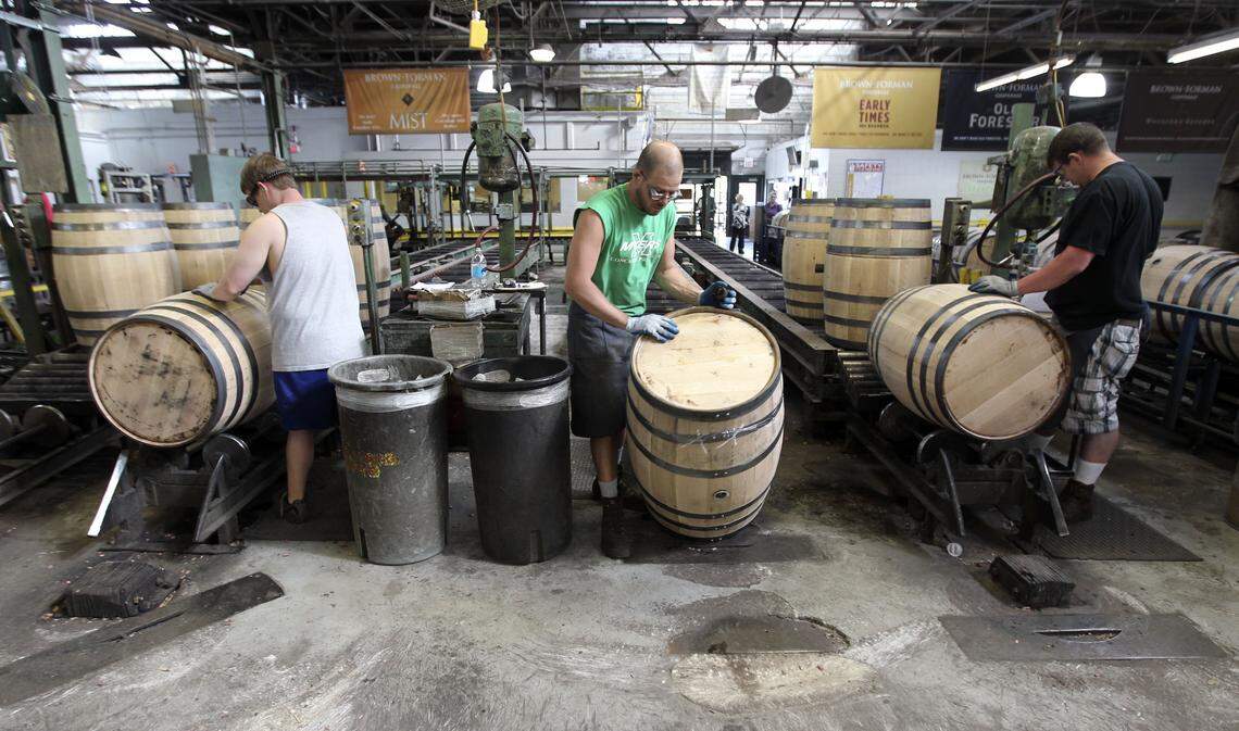 Brown-Forman cooperge employees Sam Signorin, left, Chris Pollock and Jason DeLanjay inspected the 53-gallon barrels for leaks in 2013. All the workers, more than 200, will be let go by Brown-Forman, which is closing the Louisville cooperage permanently.
