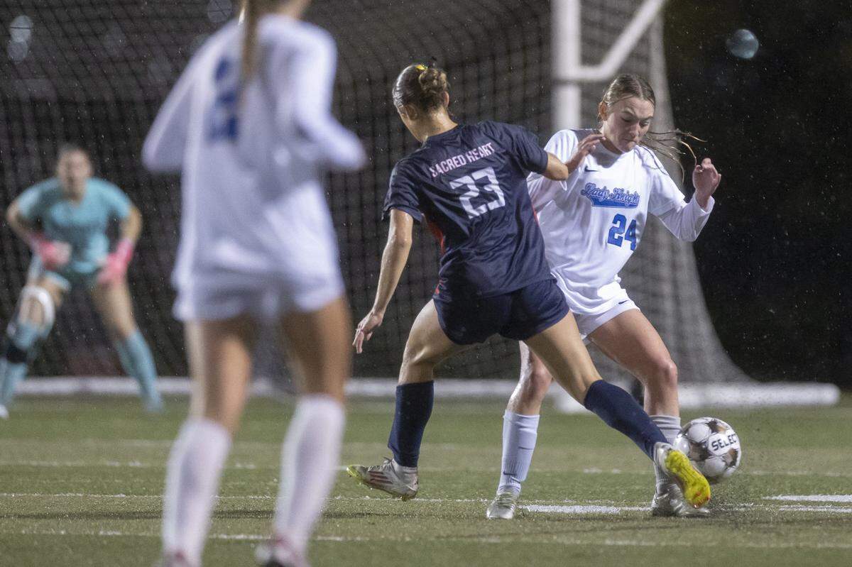 Lexington Catholic's Ryan Cornelius and Sacred Heart's Avery Krupp battle for the ball during a game in Lexington, Ky., on Wednesday, Oct. 29, 2025.