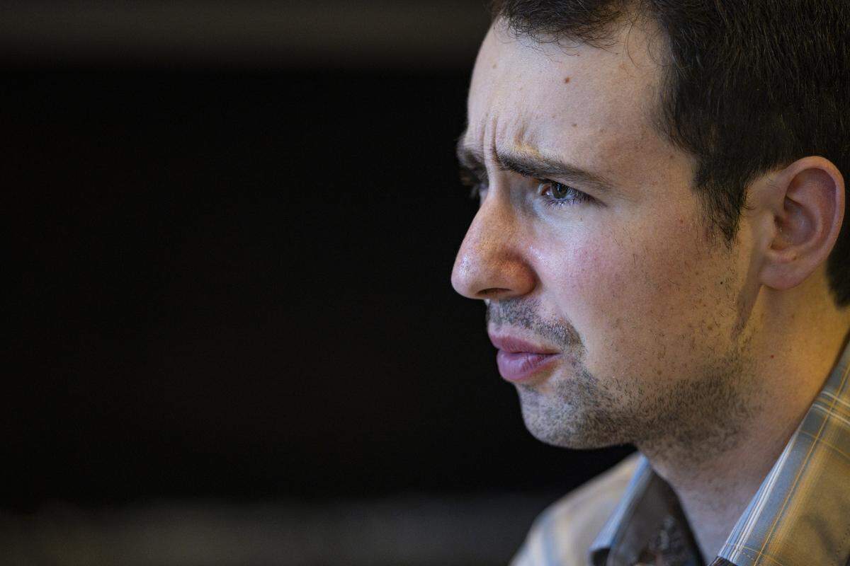 Mack Meller looks confused at a word that was played during a Scrabble club meeting on Sunday, July 27, 2025, at Sedona Taphouse in Lexington, Ky. Meller said Scrabble players are known for not being able to pronounce the words they play.