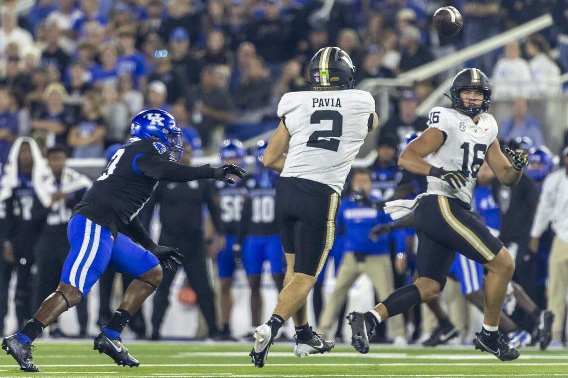Vanderbilt quarterback Diego Pavia (2) passes the ball to tight end Cole Spence (16) while under pressure from Kentucky defensive tackle Deone Walker (0).
