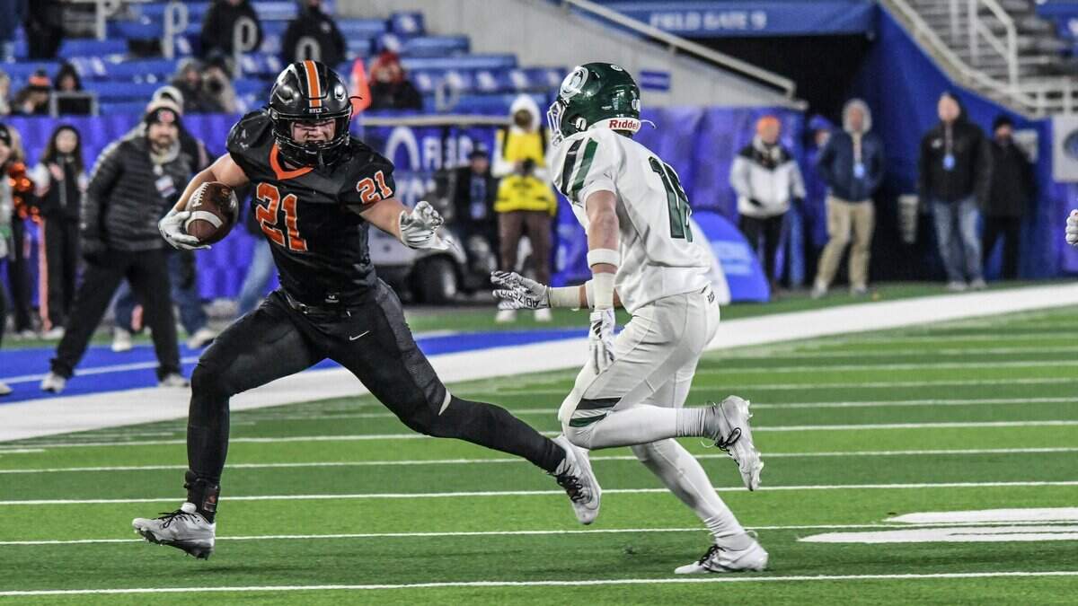 Ryle’s Jacob Savage (21) sprints past a Trinity defender in the UK Healthcare Sports Medicine Class 6A State Football Finals championship game at Kroger Field in Lexington on Dec. 7, 2024.