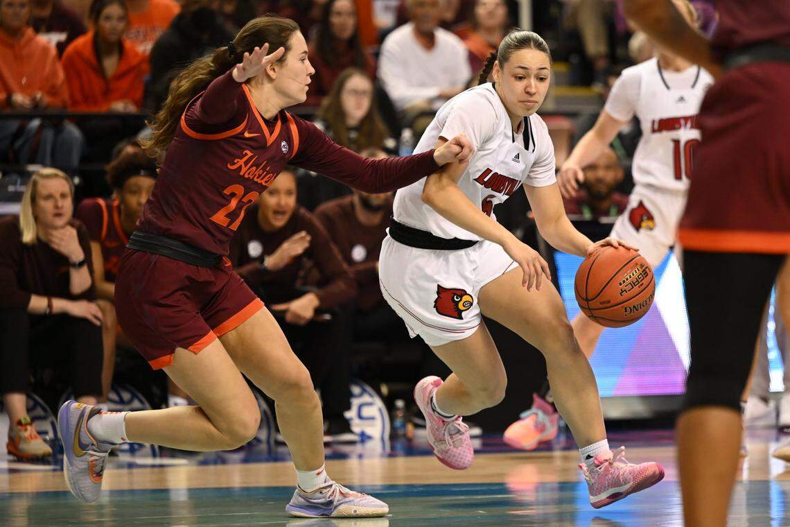 Louisville guard Mykasa Robinson, right, drives past Virginia Tech guard Cayla King (22) during the ACC Tournament.