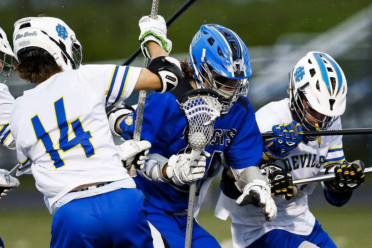 Henry Clay's Nick Walters (14) and Henry Clay's Ian Schaeffer (9) battled Lexington Catholic's Nicholas Dennis (24) during their game Saturday, April 14 at Henry Clay High School.