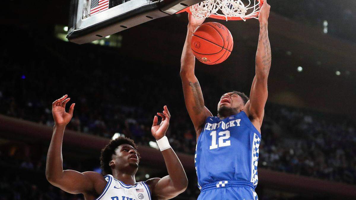 Kentucky Wildcats forward Keion Brooks Jr. (12) dunked the ball over Duke Blue Devils forward A.J. Griffin (21) during the Champions Classic at Madison Square Garden in New York City, Tuesday, Nov. 9, 2021. Duke beat Kentucky 79-71.