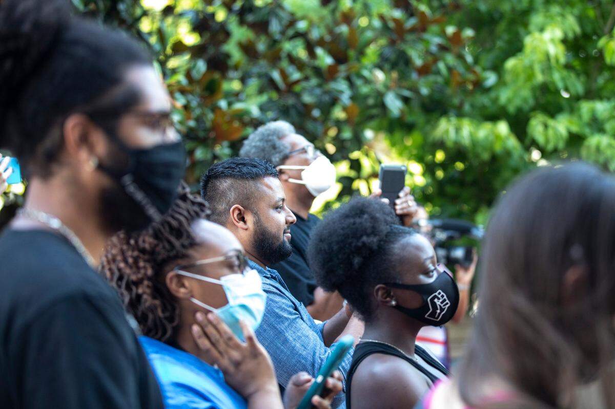 Onlookers watch as workers remove the Jefferson Davis statue from the Kentucky state Capitol in Frankfort, Ky., on Saturday, June 13, 2020.