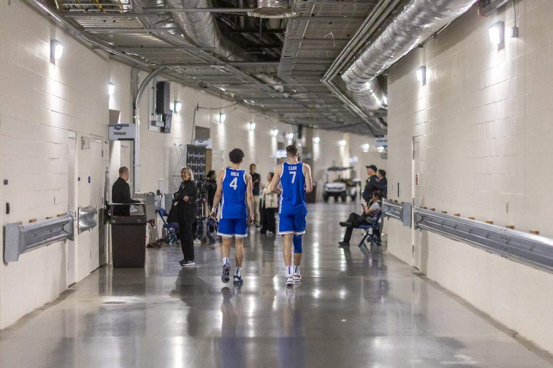Kentucky guard Koby Brea (4) and forward Andrew Carr (7) walk back to their locker room following a press conference after Friday’s loss to Tennessee during the Sweet 16 at Lucas Oil Stadium in Indianapolis.
