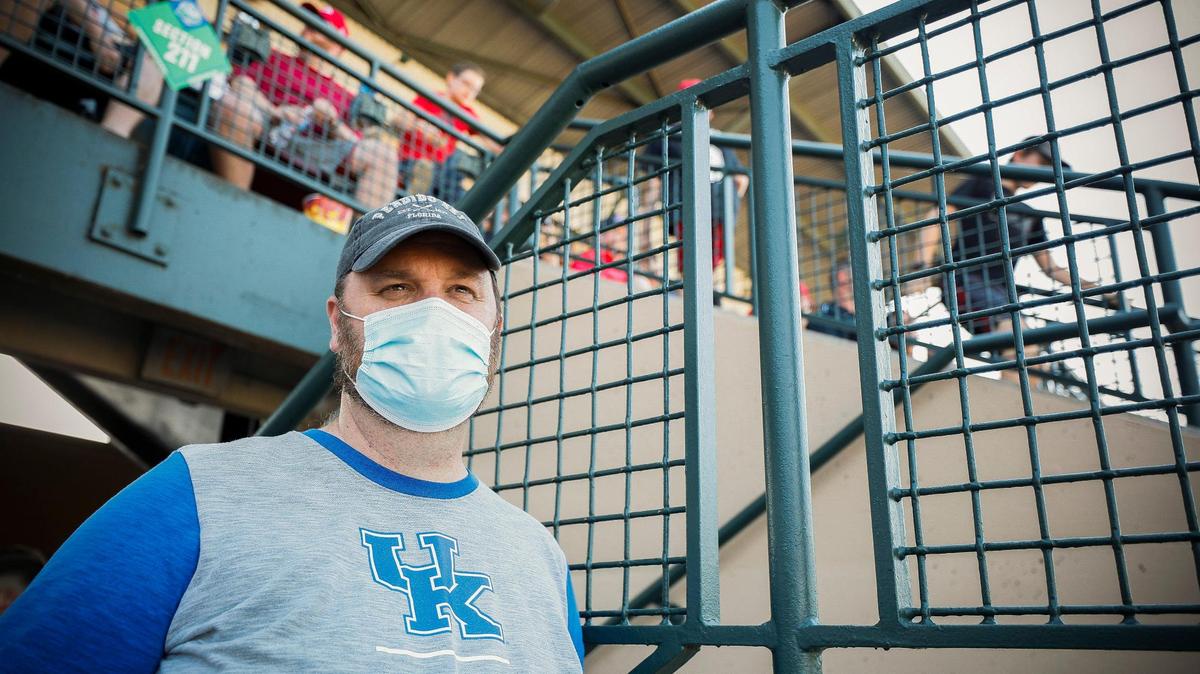 Wendell Decker, of Lexington. Ky., wears a surgical mask while watching the KHSAA State Baseball Tournament quarterfinals between Lyon County and Whitley County at Lexington Legends Ballpark in Lexington, Thursday, June 17, 2021. Although Decker is vaccinated he says he still wears a mask in public to protect himself and others from COVID-19.