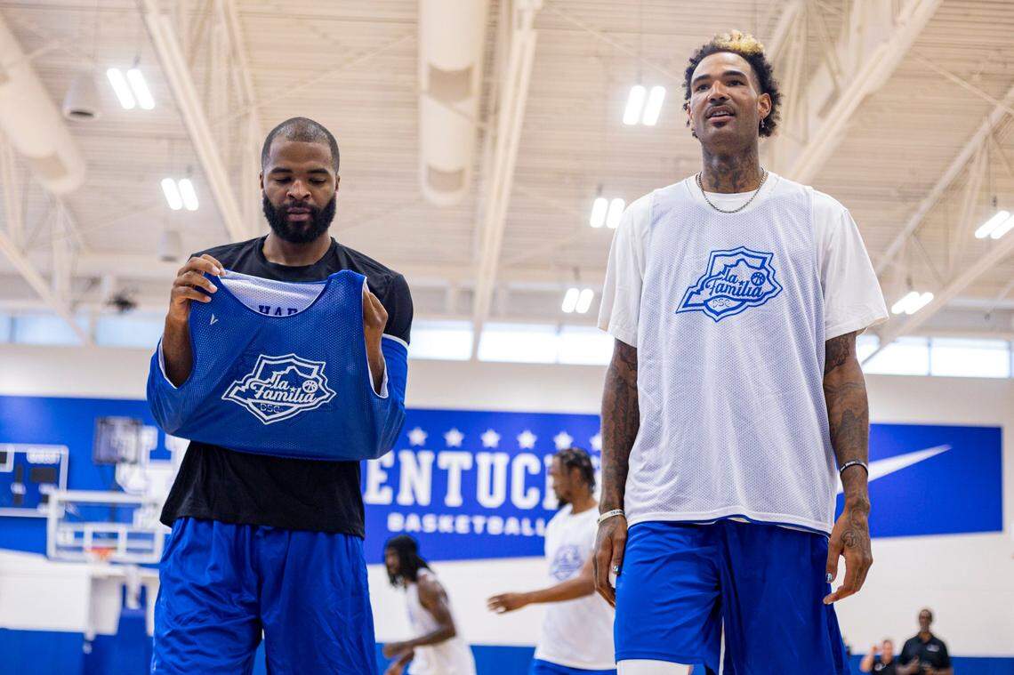 Aaron Harrison, left, and Willie Cauley-Stein walk to the baseline for drills during La Familia’s media day on Monday.
