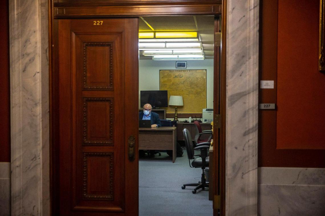 Longtime Lexington Herald-Leader Capitol Bureau Chief Jack Brammer works at his desk on his last day at the Kentucky state Capitol in Frankfort, Ky., on Wednesday, Dec. 29, 2021.