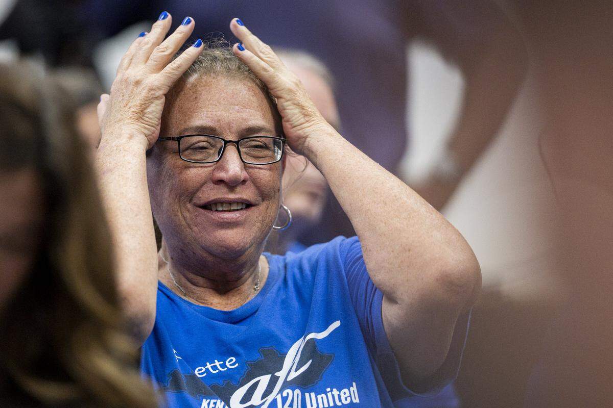 Laura Hartke raises her hands in frustration during a school board meeting on Monday, Aug. 18, 2025, at Fayette County Public Schools Central Office in Lexington, Ky.
