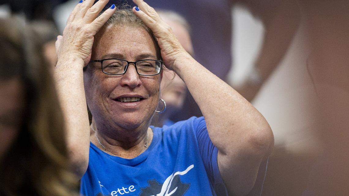Laura Hartke raises her hands in frustration during a school board meeting on Monday, Aug. 18, 2025, at Fayette County Public Schools Central Office in Lexington, Ky.