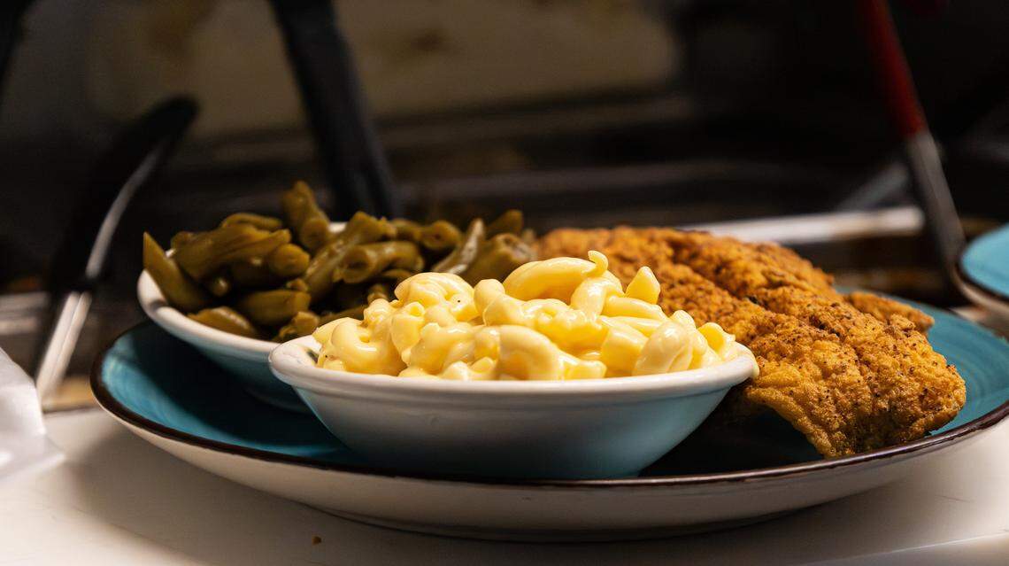 Shelby Keith fixes a hot plate of macaroni and cheese, a golden catfish fillet, and fresh green beans at Shelby's Diner on Nov. 21, 2025, in Frankfort, Ky.