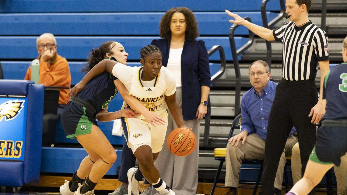 Franklin County’s Makiyia Wheeler (21) slips by Great Crossing’s Maya Custard as Flyers coach Madisen W. Sandford watched from the sideline during the Flyers’ 57-52 win Tuesday at Franklin County High School in Frankfort.