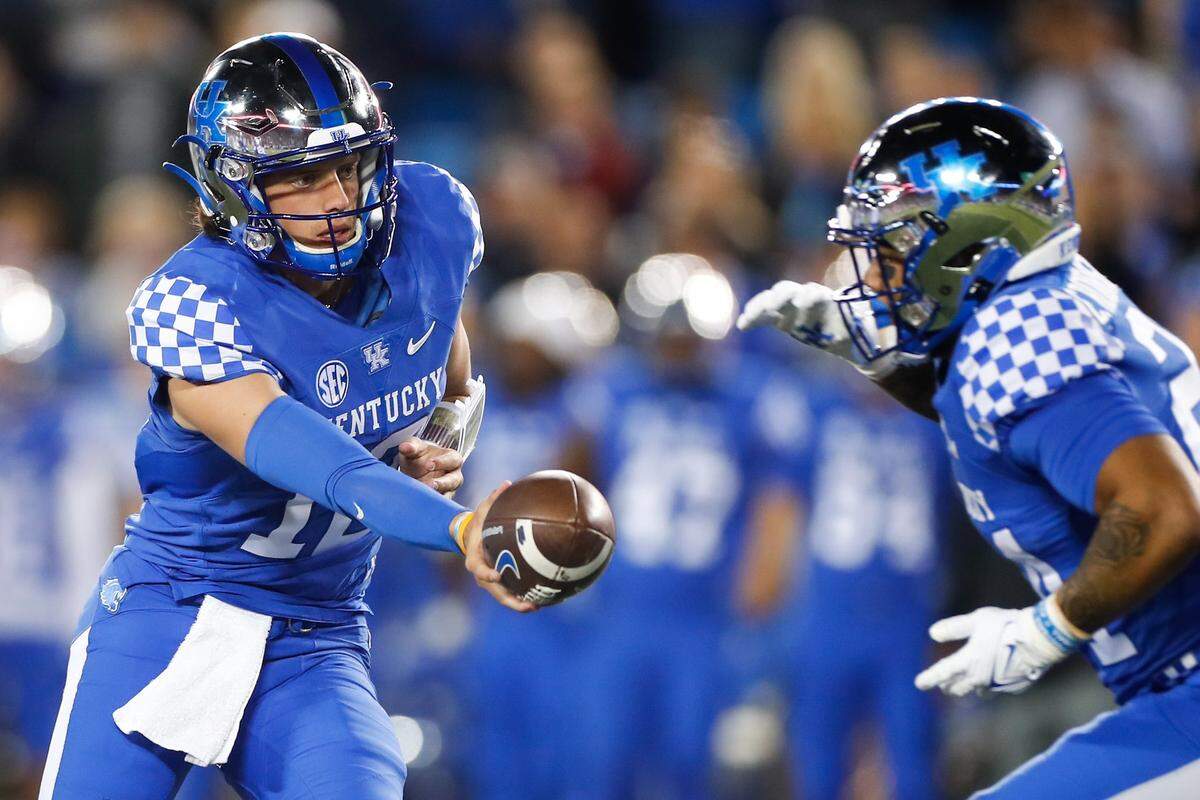 Kentucky quarterback Kaiya Sheron hands off to running back Chris Rodriguez during the Wildcats’ game against South Carolina on Saturday at Kroger Field.