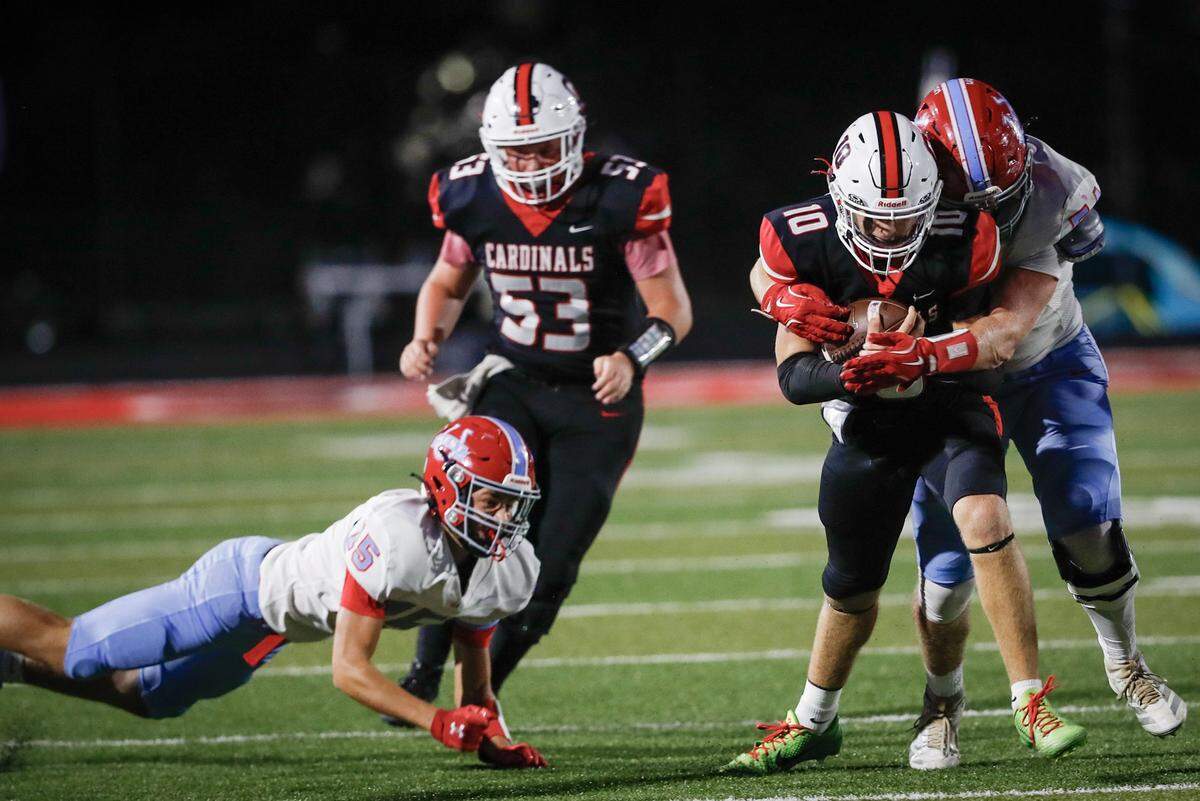 George Rogers Clark's Carter Muzic (10) pushed past offensive lineman John Flynn (53) and West Jessamine’s Jude Collier (35) before being tackled by the Colts’ Kash Thompson in the first quarter of their game at George Rogers Clark High School in Winchester on Friday.