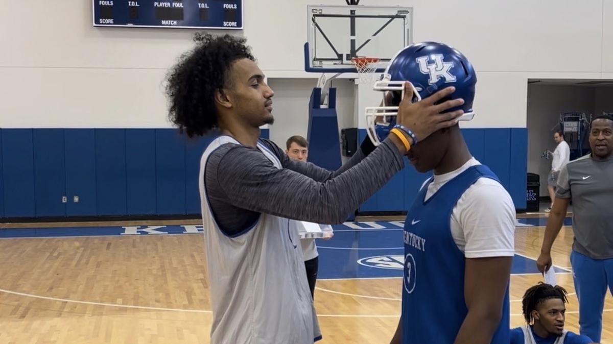 Kentucky Coach John Calipari tweeted a photo of Jacob Toppin placing a UK football helmet on freshman Adou Thiero’s head during an early preseason practice.