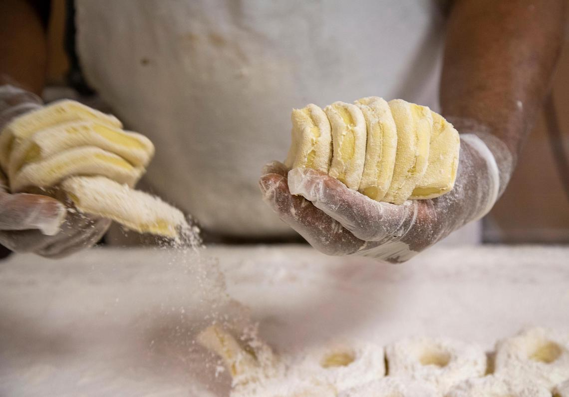 Phillip White prepares dough Wednesday before it is proofed, fried and decorated at Donut Days Bakery.
