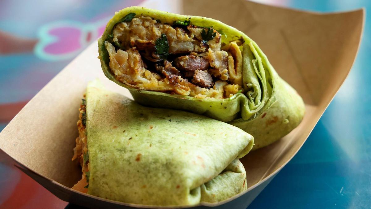 A Breakfast Burrito ($9.95) from DV8 Kitchen, made with steak, scrambled egg, potatoes, bell peppers, salsa Verde and wrapped in a cilantro-chick pea tortilla.